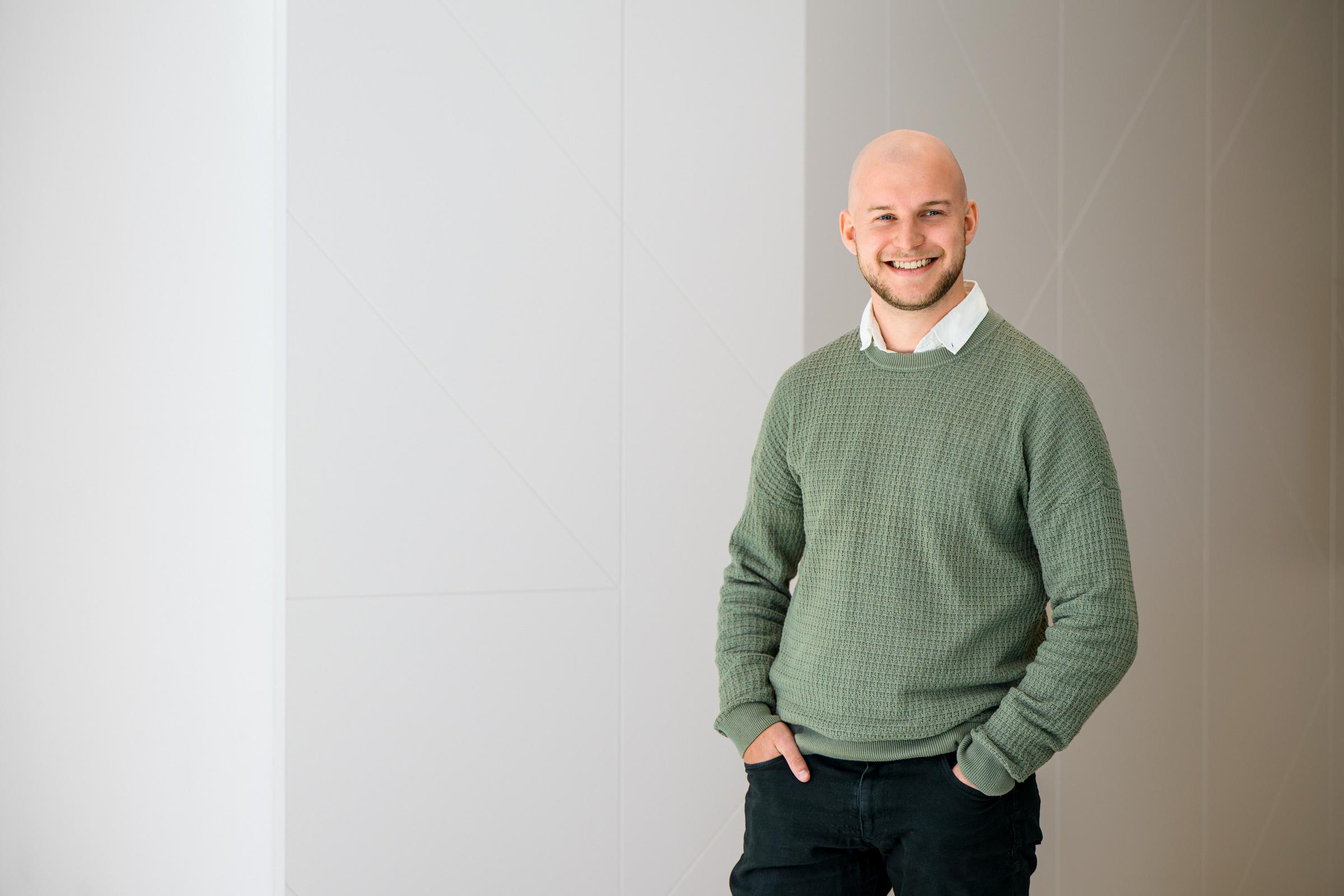 A man smiling in a workplace